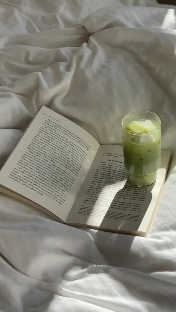 book on bed with matcha